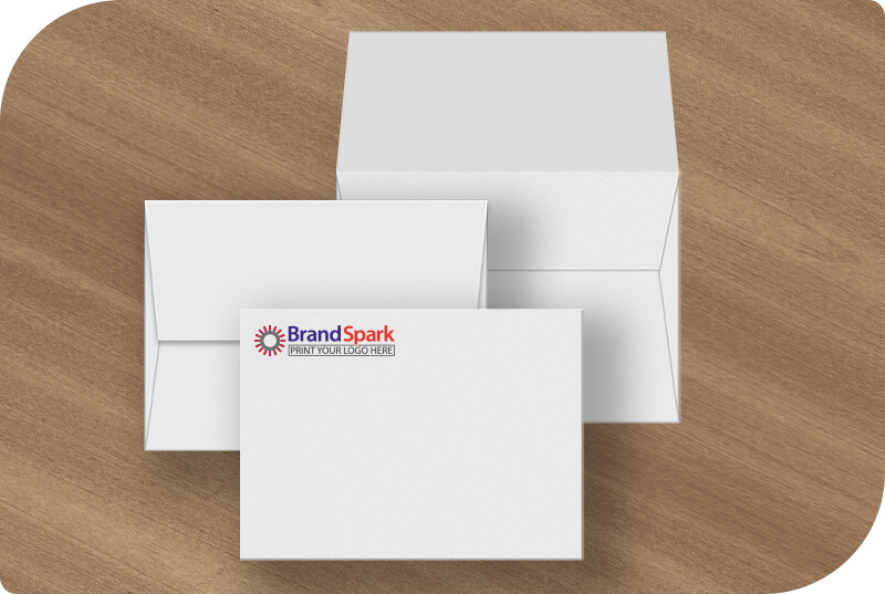 Some Announcement Envelopes on a desk showing different sides and logo printing