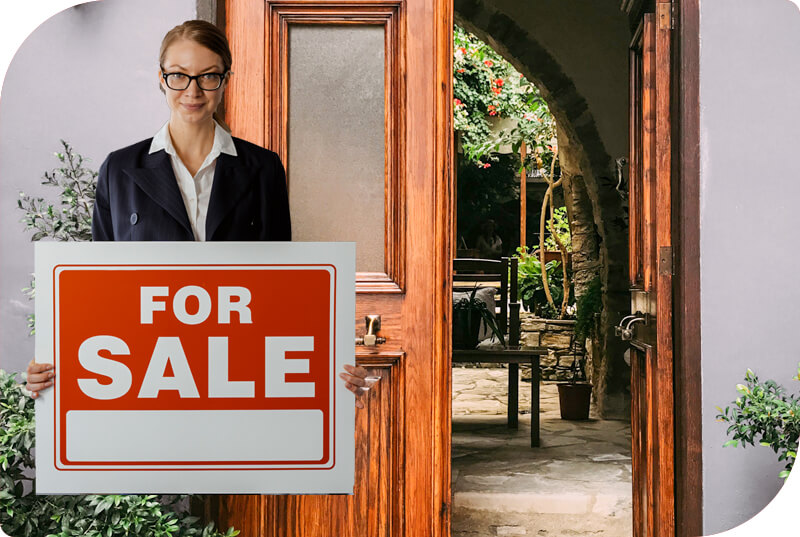 a lifesize cutout of a woman annpuncing a house sale