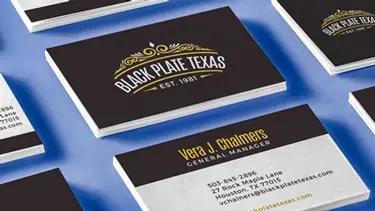 A traditional black business card on a desk